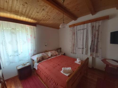 a bedroom with a red bed and a window at Apartments by the sea Merag, Cres - 11791 in Cres