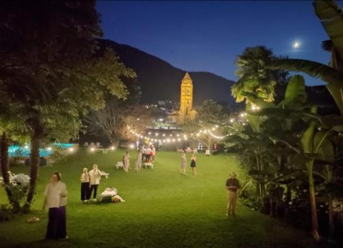 a group of people in a park at night at Hotel Fonte dei Fiori in Caslano