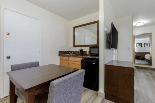 a kitchen with a table and a sink and a mirror at Comfort Suites At Sabino Canyon in Tucson