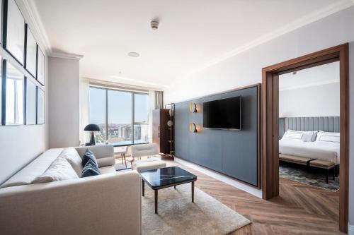 a living room with a couch and a bed at Melia Valencia in Valencia
