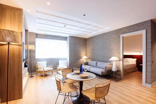 a living room with a couch and a table at THE APARTMENT by assethoteles in Torrejón de Ardoz