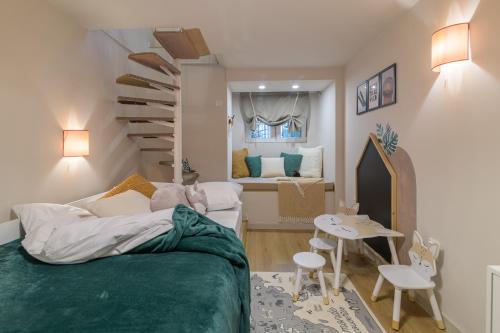 a small room with a bed and a spiral staircase at Black Sea Dolphin Apartment in Varna City