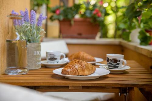 a table with two plates of croissants and cups of coffee at Black Sea Dolphin Apartment in Varna City