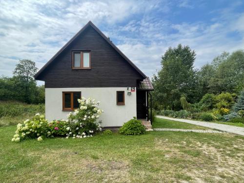 a small house with a black roof at Uniejów PORT in Uniejow