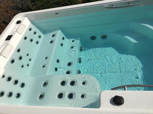 a view of the front of a bath tub at Les Chambres d'Hôtes d'Alice Dior in Blacé