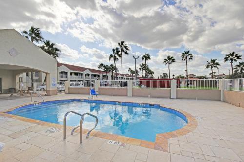 a large swimming pool in a courtyard with palm trees at Motel 6-Edinburg, TX in Edinburg