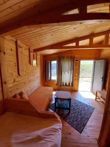 a room with two beds in a log cabin at Вилно селище МИРОВЕЦ in Malŭk Izvor