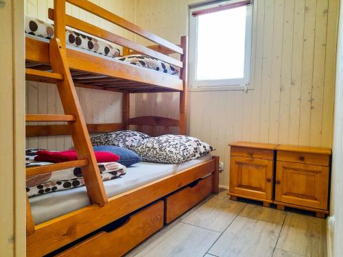 Ce lit superposé se trouve dans un dortoir avec une échelle. dans l'établissement Dom Wczasowy Smyk, à Biskupiec