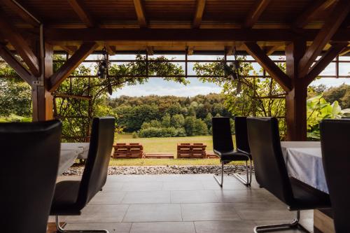 a room with a table and chairs and a view at Gostišče Iršič in Slovenska Bistrica
