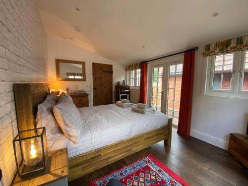 a bedroom with a large bed and a window at Nightjar in Ockley