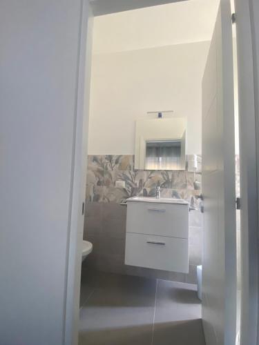 a bathroom with a sink and a toilet at Porta Saracena Rooms in Agropoli
