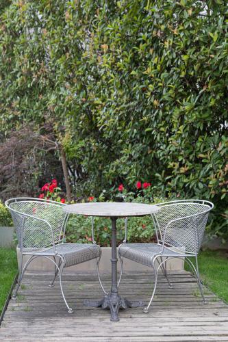 a table and two chairs on a wooden deck at Art Hotel Olympic in Turin