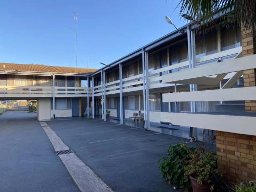 an empty parking lot in front of a building at Gateway Motor Inn in Narrandera