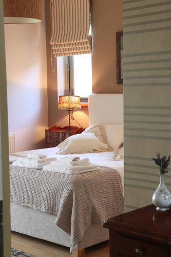 a bedroom with a white bed and a window at Virna s home in Schinias