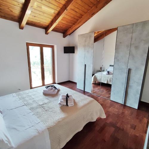 a bedroom with a large bed and a mirror at Villa Di Gioia in Caccuri