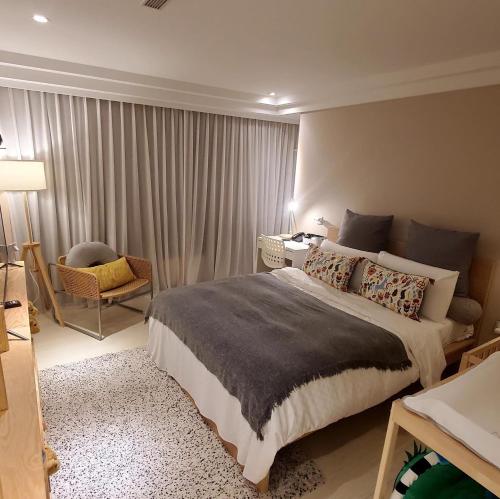 a bedroom with a bed and a desk and a chair at Yomi Hotel - ShuangLian MRT in Taipei
