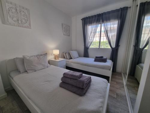A bed or beds in a room at 3 Bedroom Apartment Playa Flamenca La Zenia