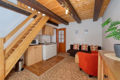 a kitchen and a living room with a loft at Chalupa RAMZOVKA in Ramzová