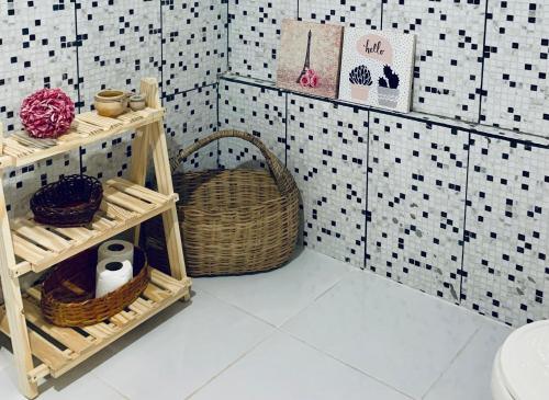 a bathroom with black and white tiled walls and a toilet at Bendita Pausa-Igatu in Igatu
