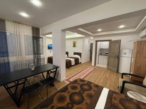 a living room with a bed and a dining room at MARLIGHT APART HOTEL in Konak