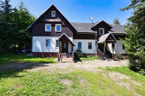 a large house with a gambrel roof at Chalupa RAMZOVKA in Ramzová