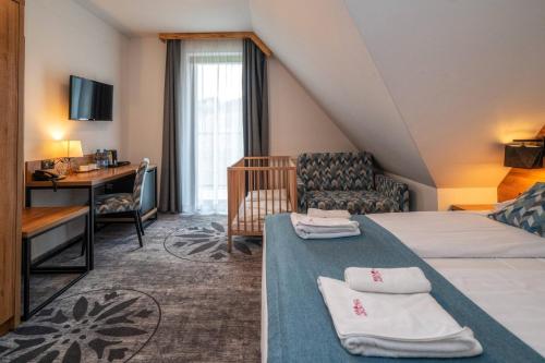 a hotel room with a bed and a desk at Malinowy Potok in Białka Tatrzanska