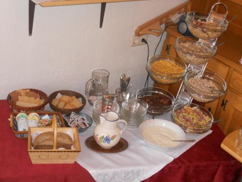 a table topped with bowls of food and other foods at Haus zur Linde in Wagrain