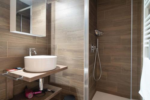 a bathroom with a sink and a shower at Relais Lucomagno in Olivone
