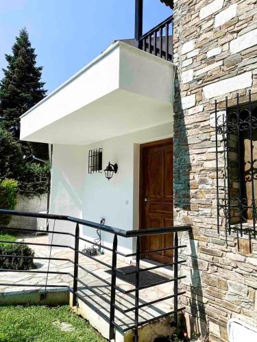 a staircase leading to a house with a wooden door at B home in Panorama in Thessaloniki