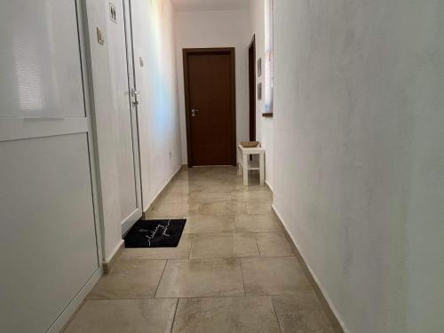 a hallway with a door and a tile floor at Петрови in Chernomorets