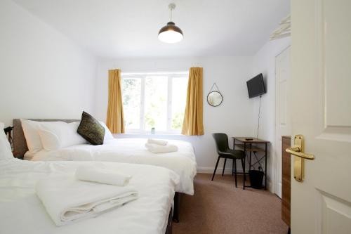 a hotel room with two beds and a window at HAVEN HOUSE DETACHED Residence in Headingley