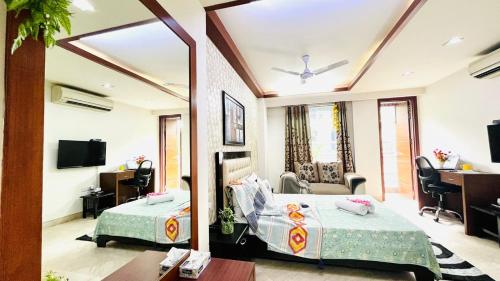 Habitación de hotel con cama y sala de estar. en BluO Cozy Studio with Balcony - Green Park HKV en Nueva Delhi