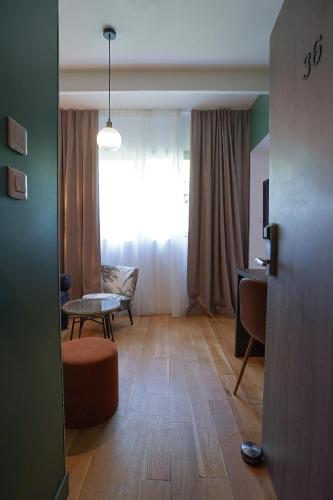 a living room with a table and a window at Quintessia in Orvault
