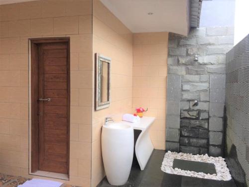 a bathroom with a white sink and a shower at The Aroma Villa Munduk in Mayong