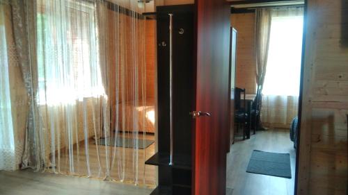 a room with a door and a window with curtains at SONATA Чан біля річки in Skole