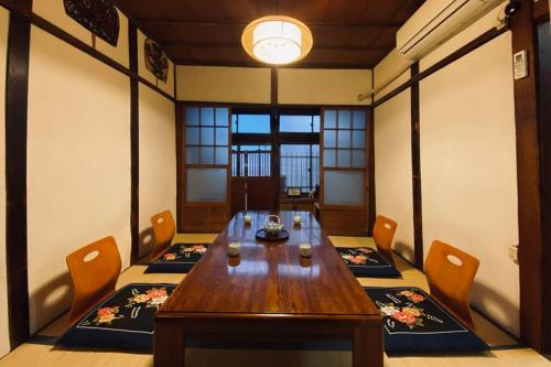 a dining room with a wooden table and chairs at Konoha house【Japanese-style guest house near Asakusa & Skytree】 in Tokyo