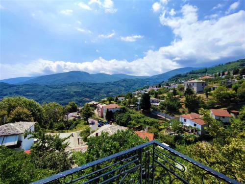 a town on a hill with mountains in the background at Antonis Tasios Guesthouse in Zagora