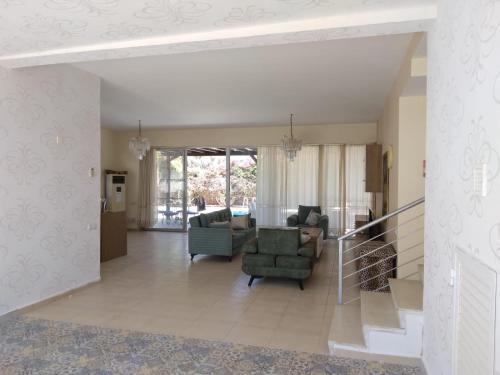 a living room with a couch and chairs in a room at Aqua Royal Alexus Luxury Holiday Apartments Girne in Kérynia
