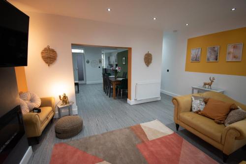 a living room with two couches and a television at Ideal Lodgings in Accrington in Accrington