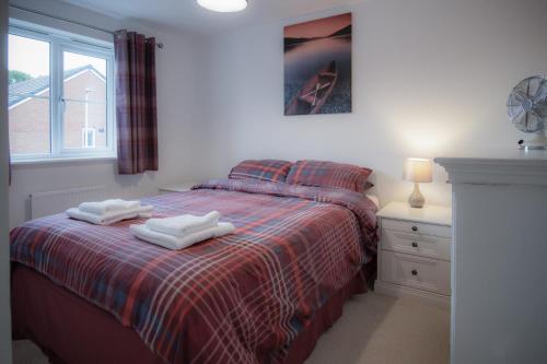 a bedroom with a bed with two towels on it at Maes Yr Odyn - 3 Bedroom Holiday Home - Narberth in Narberth