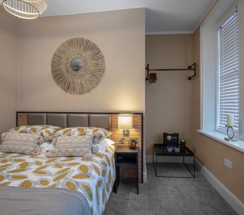 a bedroom with a bed and a desk and a mirror at Coral Boutique Apartment 2 in Blackpool