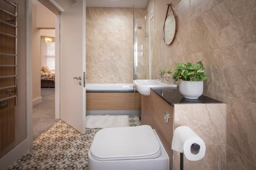 a bathroom with a toilet and a sink at Coral Boutique Apartment 2 in Blackpool