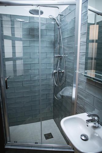 a bathroom with a shower and a sink at City-Top Vendégház in Esztergom