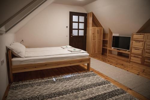 a bedroom with a bed and a tv in a room at City-Top Vendégház in Esztergom