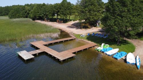 an aerial view of a dock in the water with boats at AURA Centrum Wypoczynkowo-Rekreacyjne in Sejny