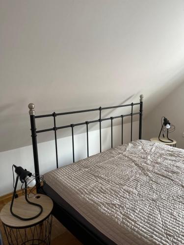a bedroom with a bed with two chairs next to it at Domek w górach in Barcice