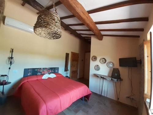a bedroom with a red bed in a room at Casale Il Ventaglio in Ficulle