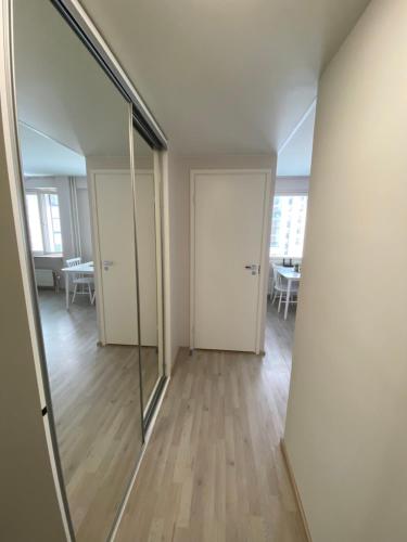 an empty room with two doors and a mirror at Korkalot in Rovaniemi
