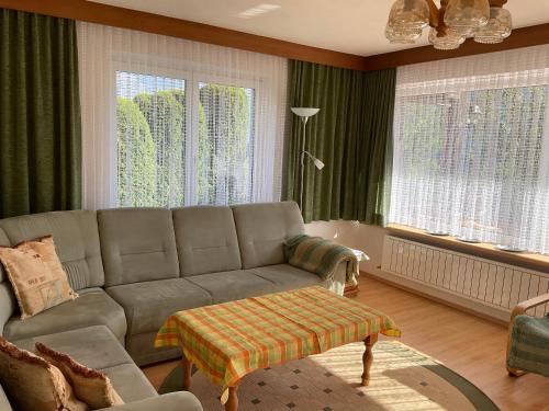 a living room with a couch and some windows at Comfortable apartment in a beautiful surrounding in Sautens