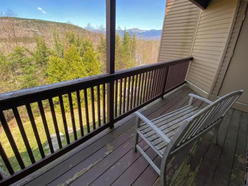 two chairs sitting on a deck with a view at C3 Crawford Ridge Townhome with Mt Washington views - just a short walk from ski lodge and slopes in Carroll